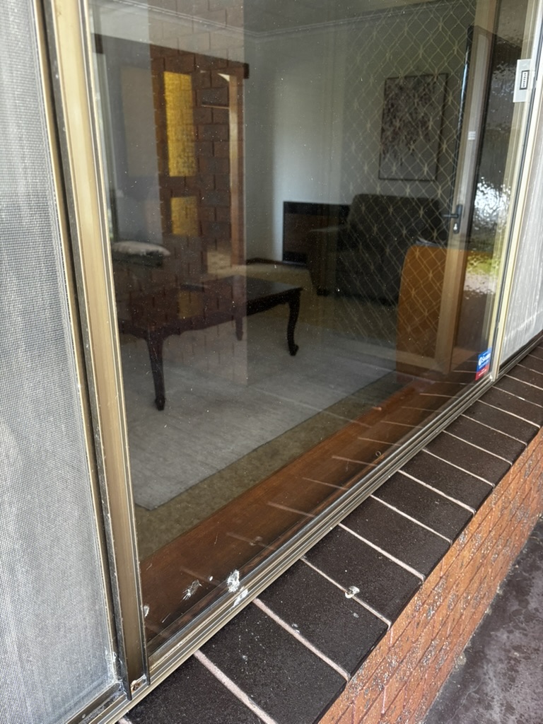 Sliding glass door before cleaning